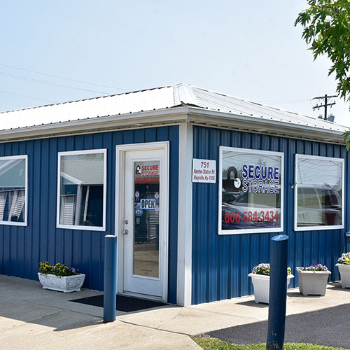 Photograph of a blue single story front office building