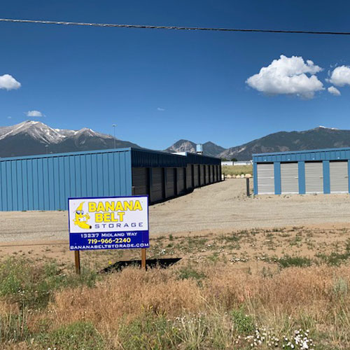 photograph of several self storage unit buildings with square red doors