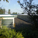 self storage buildings behind a security fence with paved parking spaces