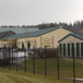 a self storage building behind a tall iron security fence