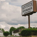 a sign that reads Hunterdon Storage Ringoes with sculpted bushes surrounding the sign