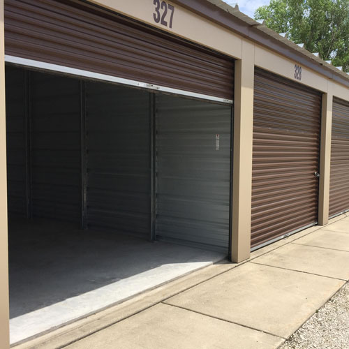 photograph of several self storage unit buildings with square red doors
