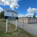 a sign that reads Lubec Safe Storage outside of a fenced in self storage facility