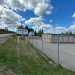 a sign that reads Lubec Safe Storage outside of a fenced in self storage facility