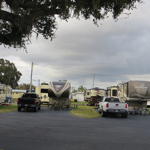 photograph of recreational vehicles parked under a blue sky