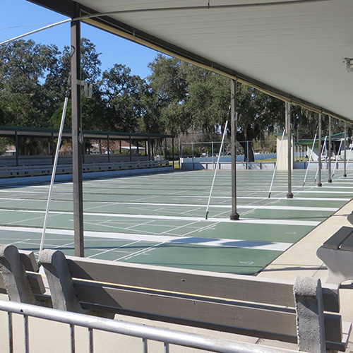 photograph of a shuffleboard court under a partial shade